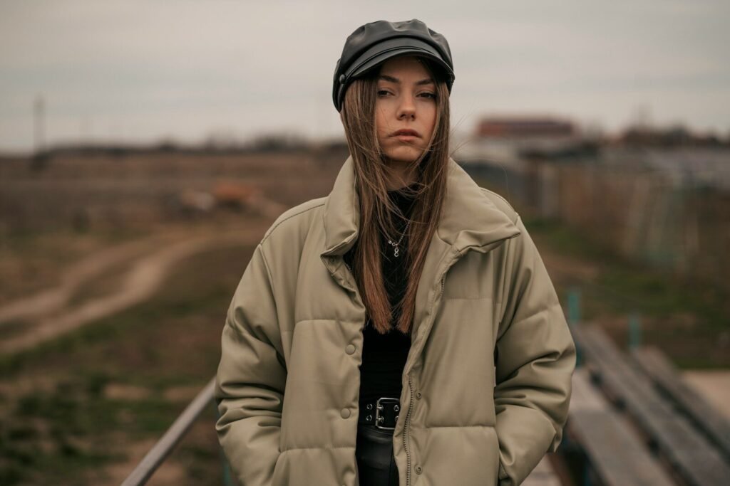a woman standing in front of a train track