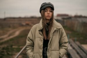 a woman standing in front of a train track