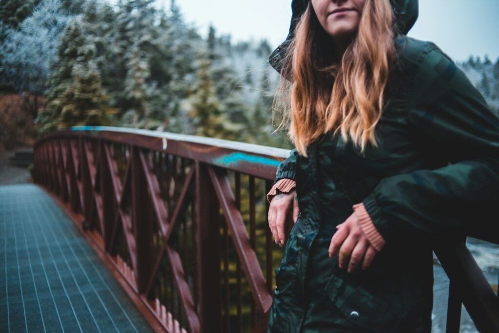 woman leaning on wooden railings